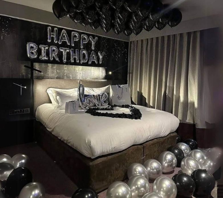 Styled hotel room with balloon ceiling and lettering